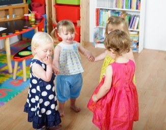group-of-happy-toddlers-holding-hands-while-playing